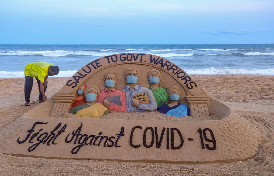 A view of a sand sculpture created by artist Sudarsan Pattnaik as a tribute to the frontline workers in their contribution for India's fight against COVID-19, at Puri beach, Saturday, May 16, 2020. Credit/PTI Photo