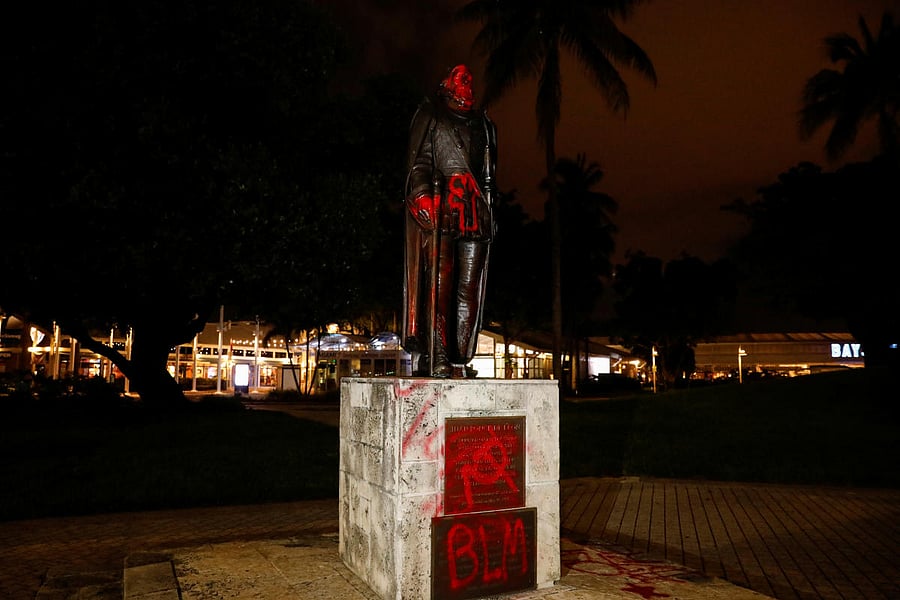 A vandalized statue of Christopher Columbus is seen at the Bayside Marketplace, after a protest against racial inequality in the aftermath of the death in Minneapolis police custody of George Floyd, in Downtown Miami, Florida, U.S., June 10, 2020. REUTERS/Marco Bello
