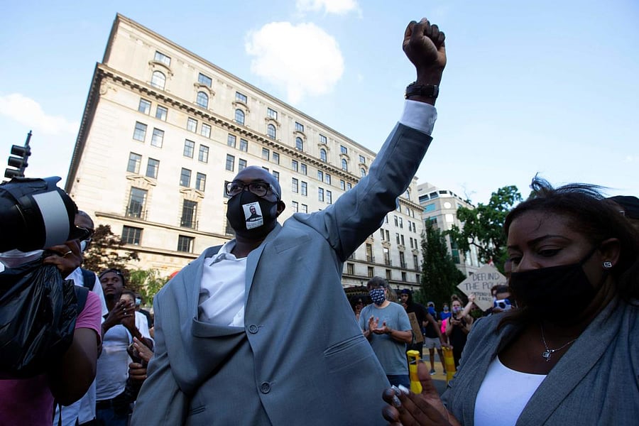 Philonise Floyd (C), George Floyd\'s brother, holds up his fist as he marches with others on Black Lives Matter Plaza near the White House, to protest police brutality and racism. Credit/AFP Photo