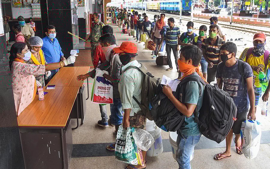 Migrants from Goa undergo thermal screening after arriving by a special train at Danapur railway station to reach their destination. Credits: PTI Photo