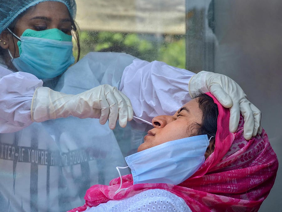 Amritsar: A medic collects samples from a women for COVID-19 swab tests at Civil Hospital, during the ongoing nationwide lockdown, in Amritsar, Thursday, June 11, 2020. (PTI Photo)(PTI11-06-2020_000051B)