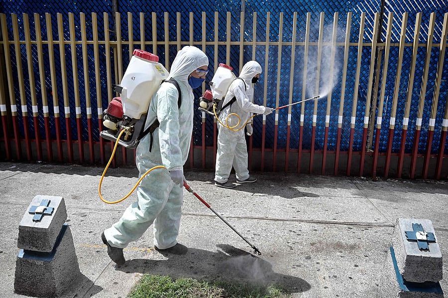 Workers sanitize the railings surrounding the General Hospital's triage area for COIVD-19 patients in Mexico City. Credits: AFP Photo
