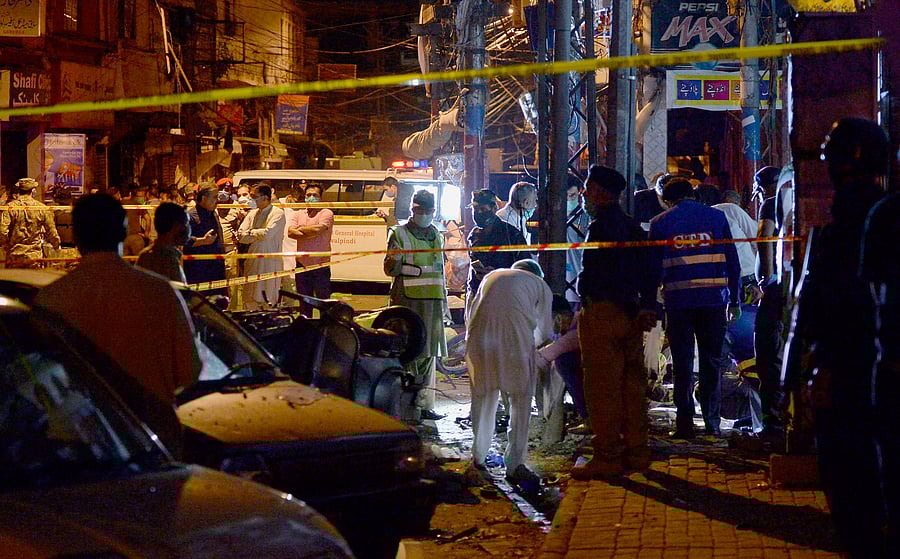 Pakistan's security officials examine the site of a bomb explosion that ripped through a bazaar in Rawalpindi, Pakistan. Credit: AP