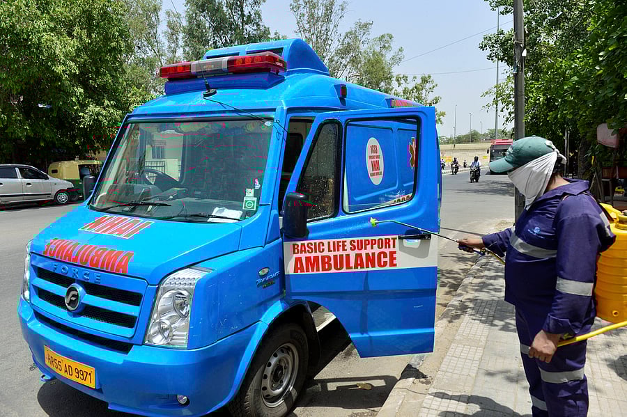 A MCD worker sprays disinfectant on an ambulance, in wake of the coronavirus pandemic, during the ongoing nationwide lockdown, in New Delhi. Credit: PTI
