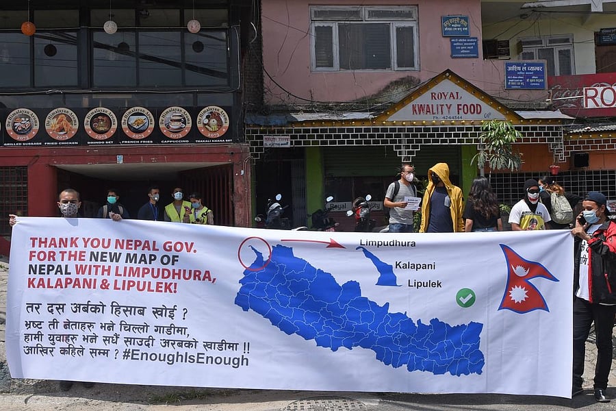 In this picture taken on June 13, 2020, protesters hold a banner with a new map during a demonstration against the government's handling of the fight against the COVID-19 coronavirus, in Kathmandu. Credit/AFP Photo