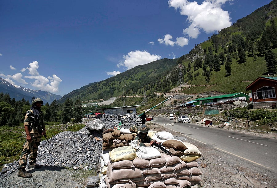 India's Border Security Force (BSF) soldiers stand guard at a checkpoint along a highway leading to Ladakah. Credit: Reuters