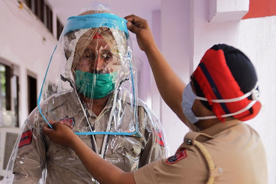  In this file photo taken on April 16, 2020 police personnel try Personal Protective Equipment (PPE) during a government-imposed nationwide lockdown as a preventive measure against the COVID-19 coronavirus, in Amritsar. Credit/AFP Photo
