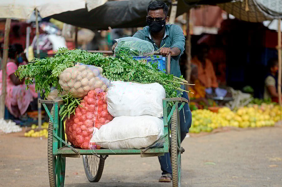 A vendor pushes his vegetable cart at a market after a lockdown was reimposed as a preventive measure against the spread of the COVID-19. Credits: AFP Photo