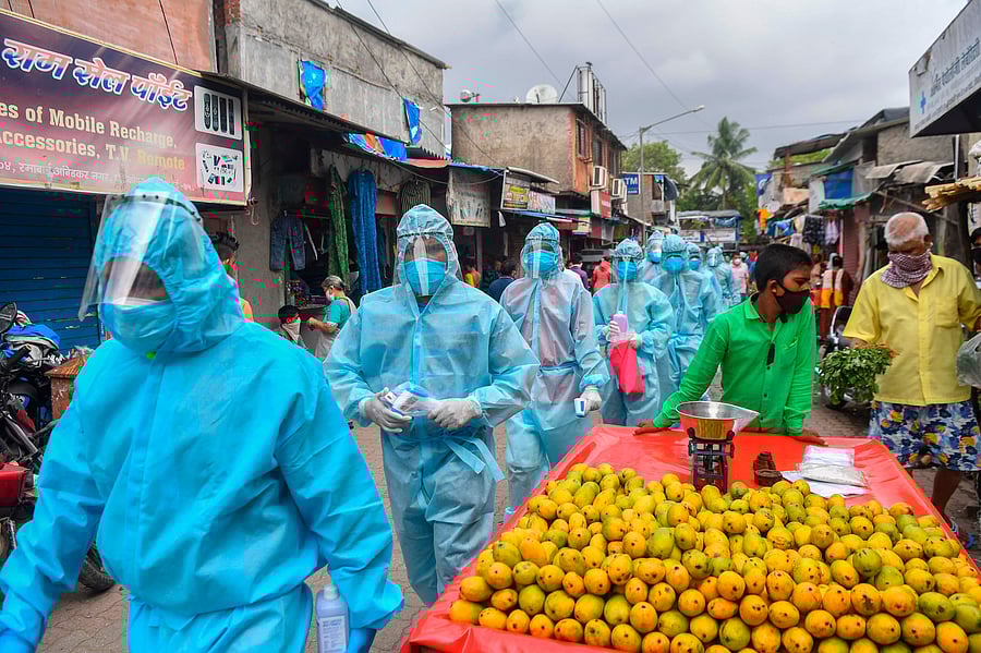 edical staff along with Hindu hardline group Rashtriya Swayamsevak Sangh (RSS) volunteers wearing Personal Protective Equipment (PPE) gear walk through a market for a door-to-door medical screening inside a slum to fight against the spread of the COVID-19. Credits: AFP Photo