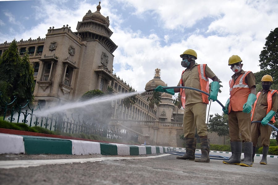 Workers sanitise Vidhana Soudha premises in Bengaluru on Friday. DH Photo/S K Dinesh