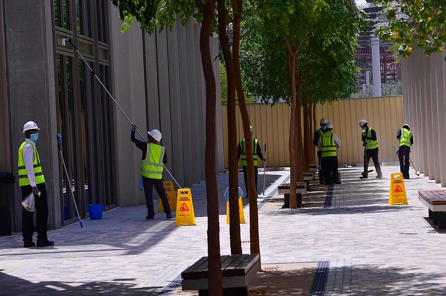 Worker clean outsite the Dubai Expo 2020 site, under construction in the Emirati city. AFP