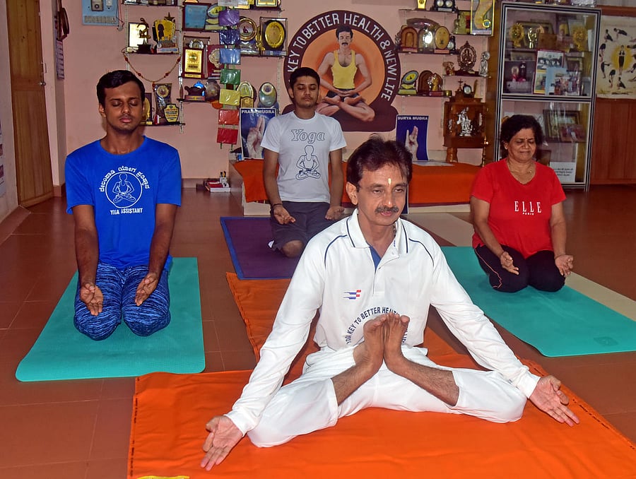 Yoga expert Gopalakrishna Delampady demonstrated Yoga using digital media Google Meet and Facebook live at his residence in Yeyyadi in Mangaluru, on the occasion of International Day of Yoga on Sunday. DH Photo/Govindraj Javali