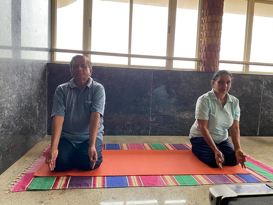 MLA K G Bopaiah performs Yogasana at his house. DH Photo