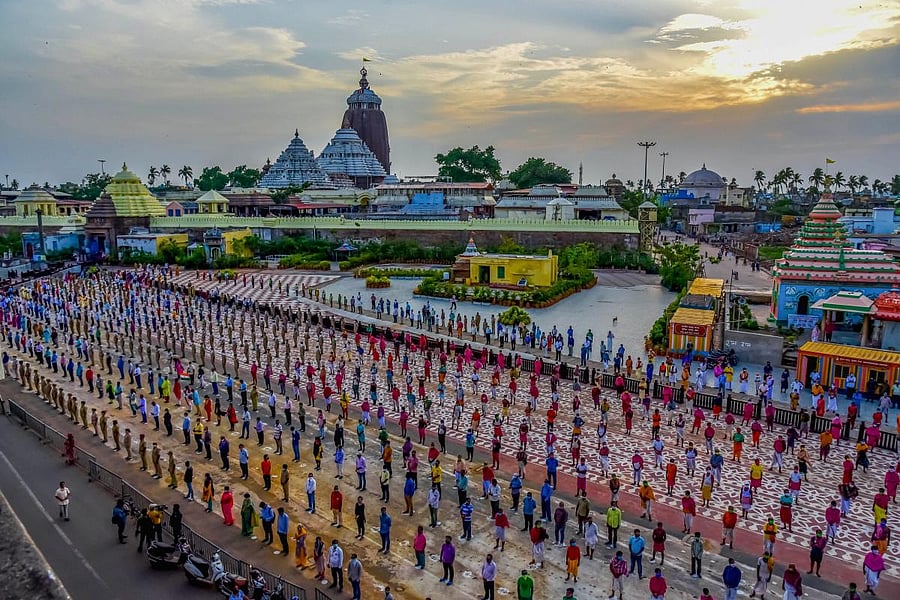 People sing 'Bande Utkal Janani', Odisha's unofficial state song to motivate COVID-19 warriors in front of Jagannath Temple, during the ongoing COVID-19 lockdown, in Puri, Saturday, May 30, 2020. Credit/PTI Photo
