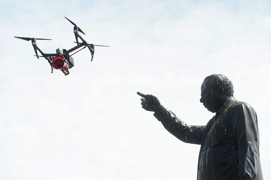 A drone being used by police to monitor activities of people and to spread awareness announcements is pictured next to a statue of late former chief minister of Tamil Nadu C. N. Annadurai, after a lockdown was reimposed as a preventive measure against the spread of the COVID-19, in Chennai on June 19, 2020. (PTI Photo)