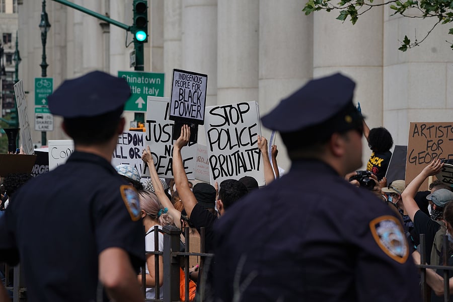 New York City Police look on as protesters march into Manhattan from the Brooklyn Bridge over the death of George Floyd by Minneapolis Police on June 19, 2020 in New York. - The US marks the end of slavery by celebrating Juneteenth, with the annual unofficial holiday taking on renewed significance as millions of Americans confront the nation's living legacy of racial injustice. (Photo by AFP)