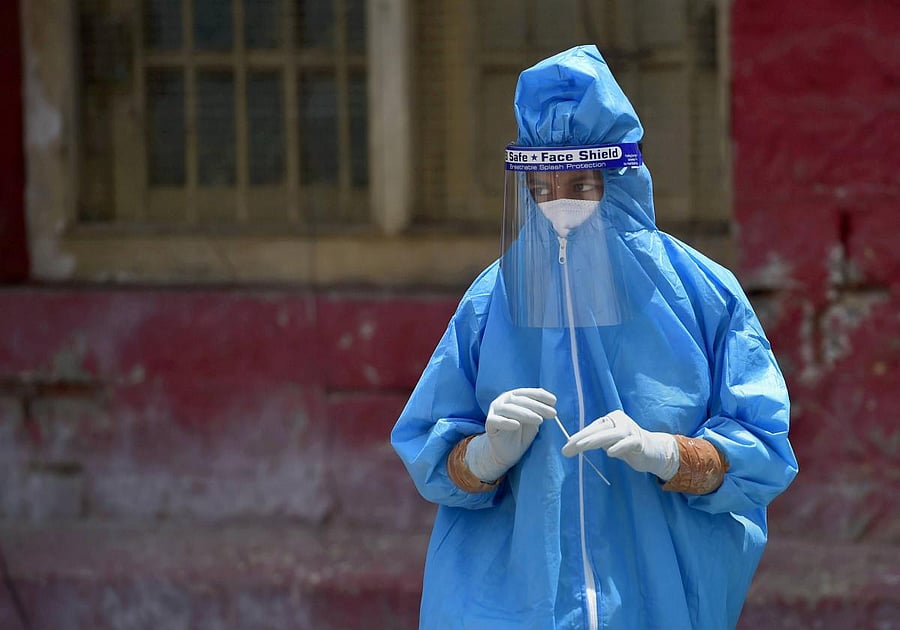  A medic wearing a PPE collects samples for COVID-19 tests (PTI Photo)