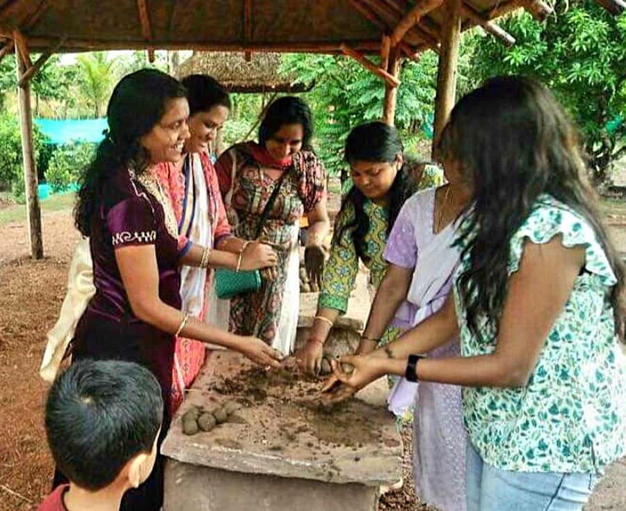Women prepare seed balls last year.