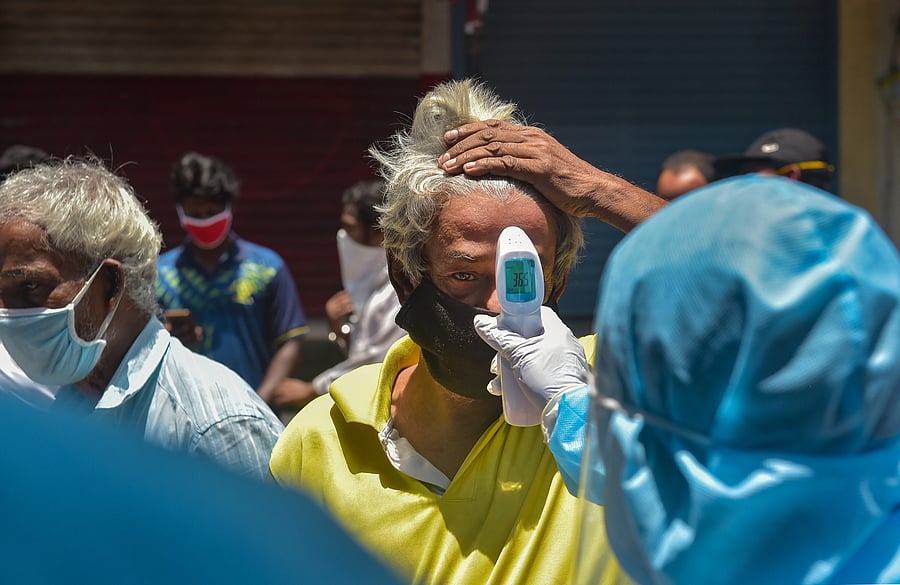  Volunteers conduct thermal screening at Dharavi, during the ongoing COVID-19 lockdown, in Mumbai. Credit: PTI