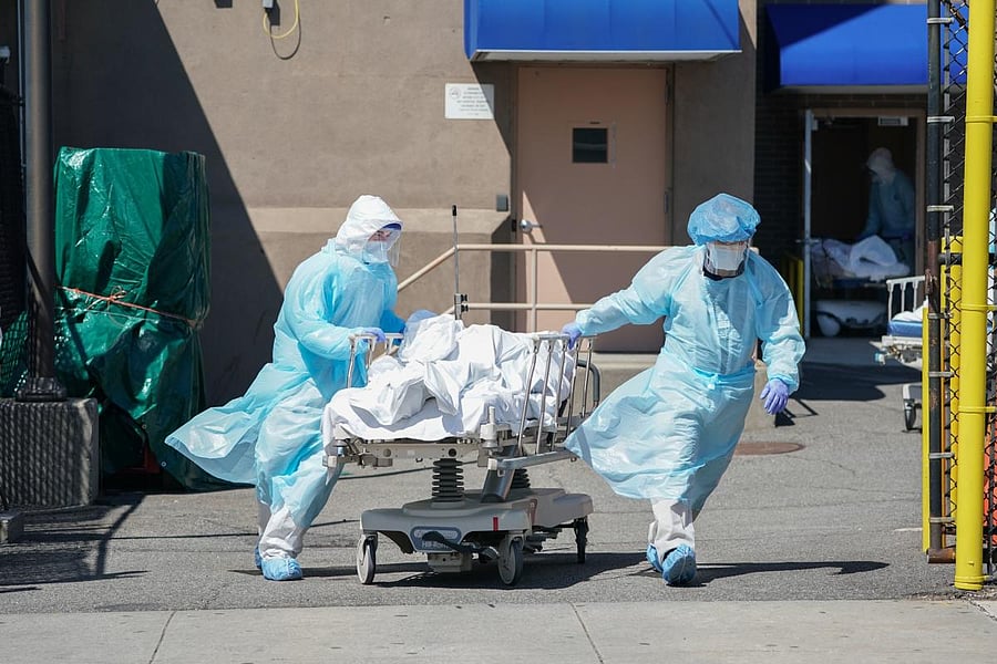 In this file photo taken on April 06, 2020 bodies are moved to a refrigeration truck serving as a temporary morgue at Wyckoff Hospital in the Borough of Brooklyn in New York. Credid/AFP Photo