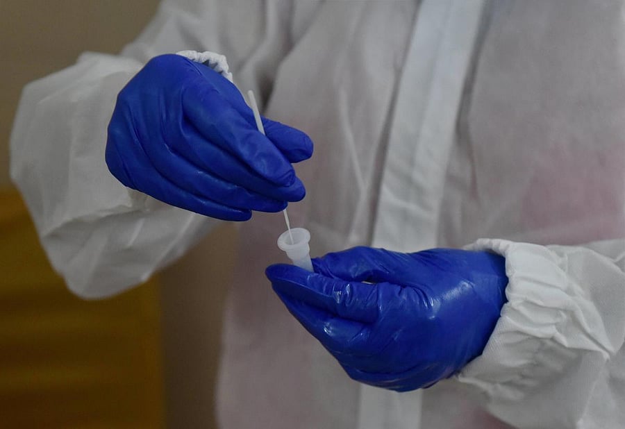 A medic collects samples via Rapid Antigen for Covid-19 test at NDMC Child Welfare Center in Sarojini Nagar, during the ongoing nationwide lockdown, in New Delhi, Tuesday, June 23, 2020. Credit/PTI Photo