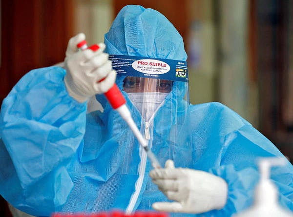 A healthcare worker wearing protective gear adds sodium citrate, an anticoagulant, to blood samples that were collected from the residents to test for the coronavirus disease (COVID-19) at a health center in a residential area in Ahmedabad, India, June 24, 2020. Credit: Reuters