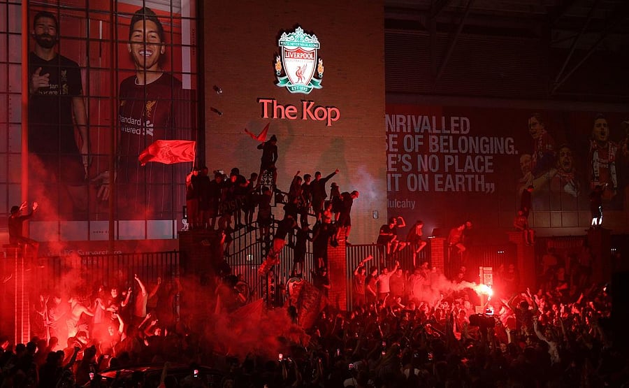 Fans celebrate Liverpool winning the Premier League title outside Anfield stadium in Liverpool, north west England on June 25, 2020, following Chelsea's 2-1 victory over Manchester City. Credit/AFP Photo