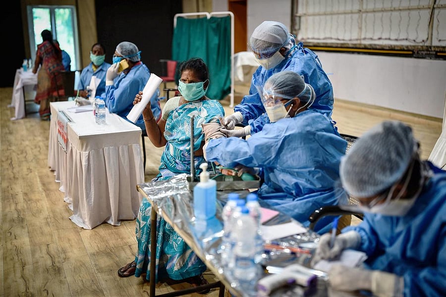  Healthcare workers check the blood pressure of a sanitary worker during coronavirus campaign (PTI Photo)