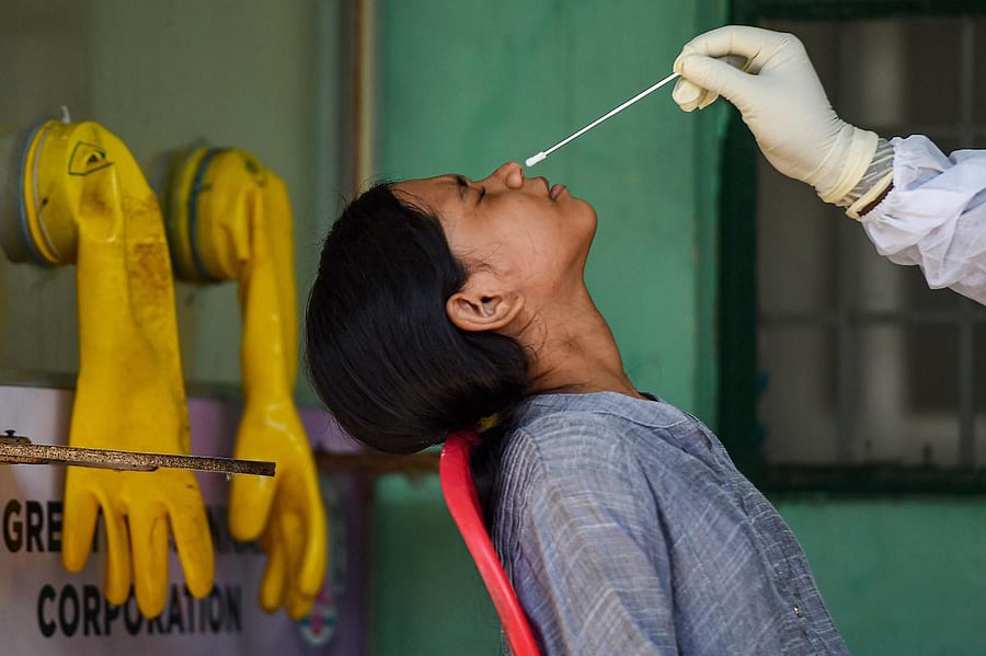 A health worker collects a sample of a girl for COVID-19 test, during the nationwide lockdown to curb the spread of coronavirus (PTI Photo)