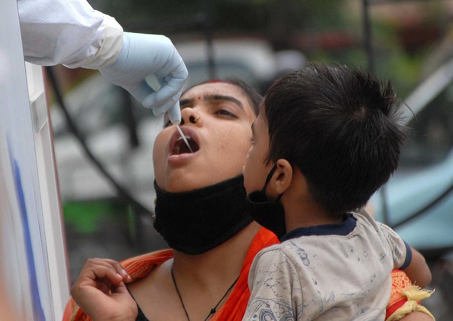 A medic takes a swab sample of a woman for COVID-19 test (PTI Photo)