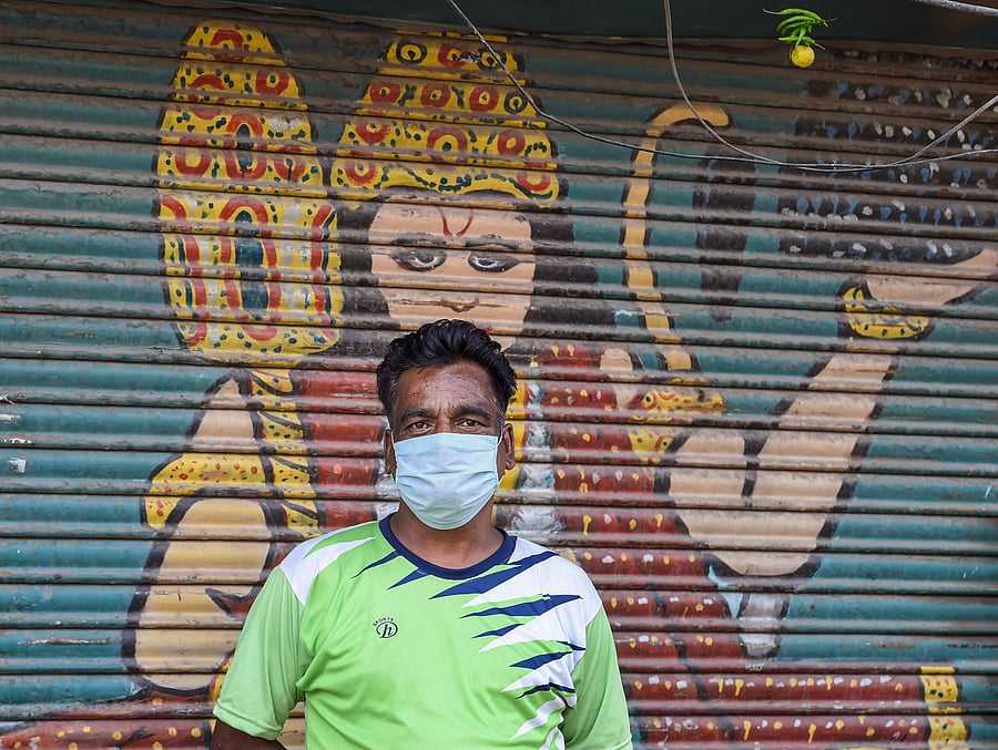 A trader wearing a mask stands in front of a closed shop at Sadar Bazar during the ongoing COVID-19 lockdown, in New Delhi, Saturday, June 6, 2020. Traders of Sadar Bazar market met district magistrate Nidhi Srivastava to inform her of the hardship they were facing due to the closed market, which falls in containment zone. (PTI Photo)