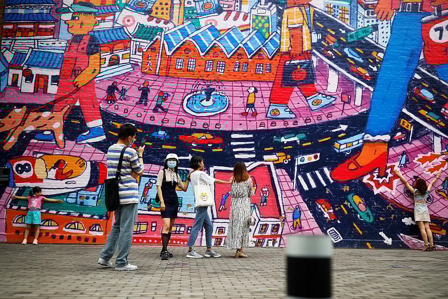 People wear protective masks as they walk in a former industrial park that has been converted to an art district on the Dragon Boat Festival public holiday after a new outbreak of the coronavirus disease (COVID-19) in Beijing, China. Credit: REUTERS