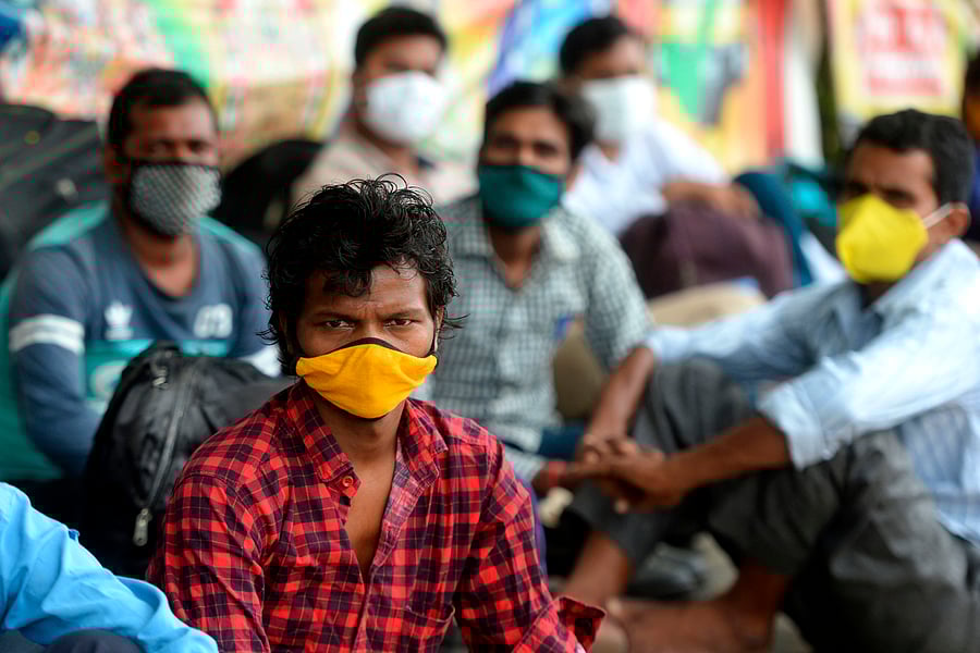 Stranded migrant workers wait to board a special train to Bihar state from MGR central railway station after the government eased a nationwide lockdown imposed as a preventive measure against the Covid-19. Credits: AFP Photo
