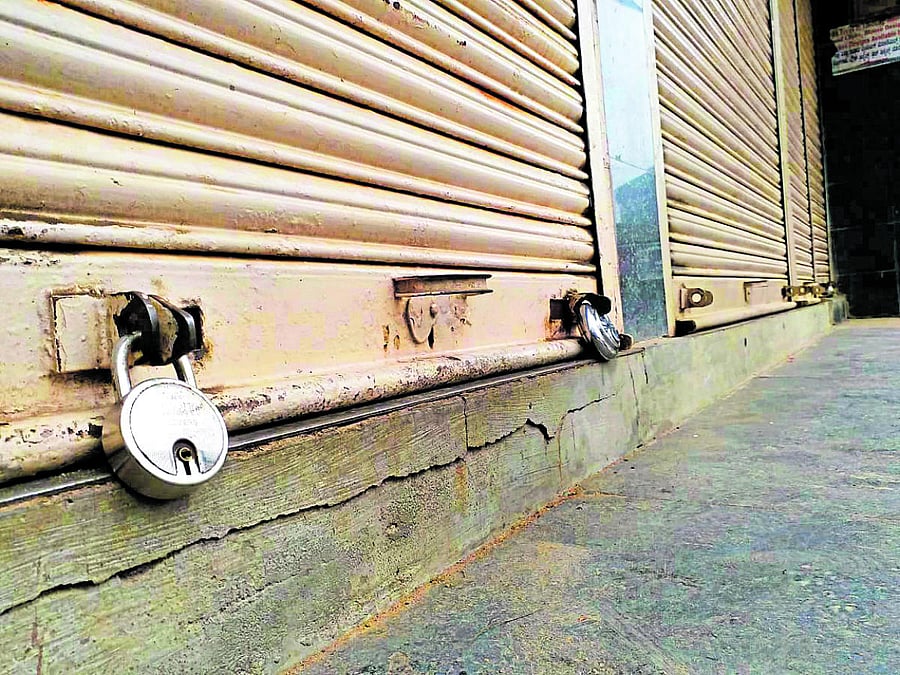 Shopkeepers voluntarily downed the shutters in Madikeri on Sunday. DH Photo