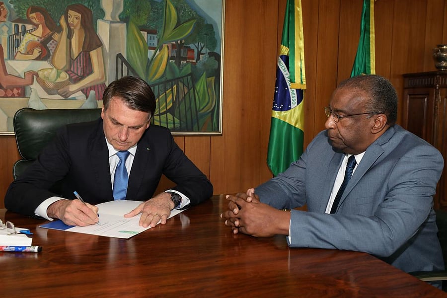 Handout picture released by Brazilian Presidency press office of President Jair Bolsonaro (L) and his new Minister of Education Carlos Alberto Decotelli, the first black minister in his cabinet, at Planalto Palace in Brasilia, Brazil, on June 26, 2020. Credit/AFP