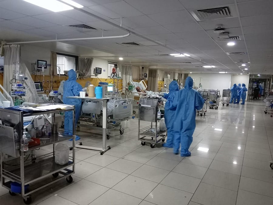 Doctors moving around wearing the personal protective equipment (PPE) inside the 15-bed, fully operational Covid ICU at St John's Medical College Hospital.