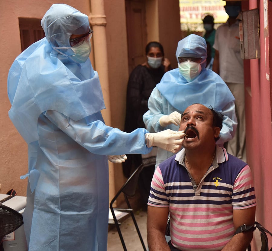 Medics collecting a samples for Covid 19 test, from staffs of VVPuram traffic police station during the Covid 19 positive cases spread out in Bengaluru on Wednesday, 17 June, 2020. Photo by B K Janardhan