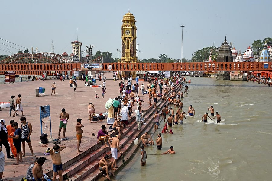 Devotees take a dip at Har Ki Pauri ghat on the banks of the river Ganges (AFP Photo)