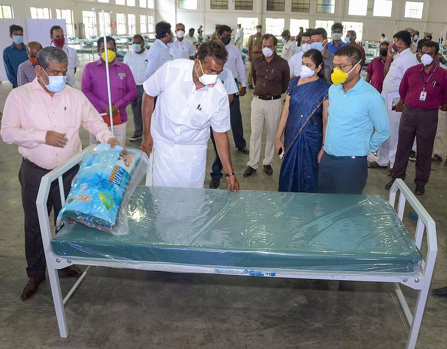 Rural Development Minister SP Velumani checks beds, installed inside Codissia Trade Center, for the treatment of COVID-19 patients (PTI Photo)