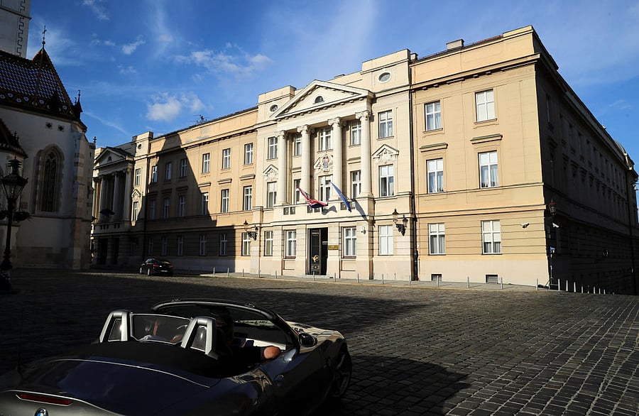 People drive a car in front of the Croatian Parliament building ahead of parliamentary elections, amid the spread of the coronavirus disease. Reuters