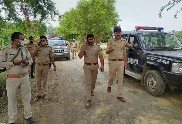 Police personnel investigate the site of encounter between the policemen and criminals in Kanpur. The encounter took place when the police team was approaching to arrest Vikas Dubey. Credit: PTI