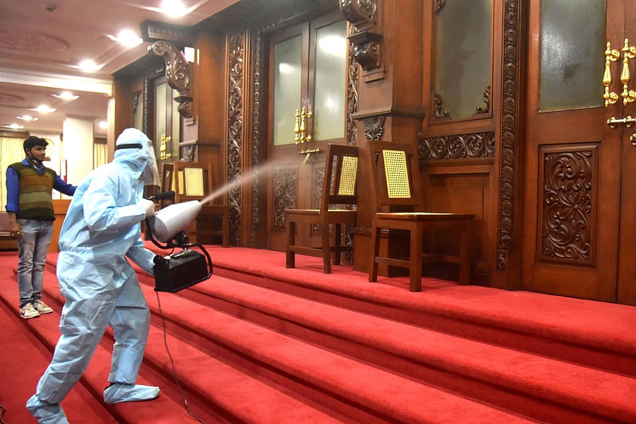 Workers sanitising the first floor offices in Vidhana Soudha in Bengaluru on Monday. DH photo/S K Dinesh