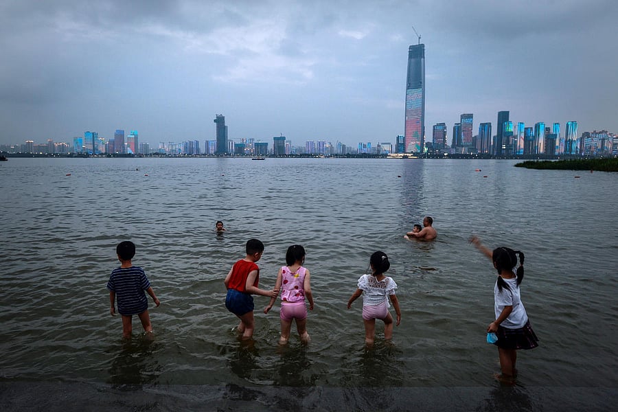 People take a dip on a summer day in the Yangtze River, where the water level has risen following heavy rainfall, in Wuhan, Hubei province, China June 29, 2020. Credit/Reuters Photo