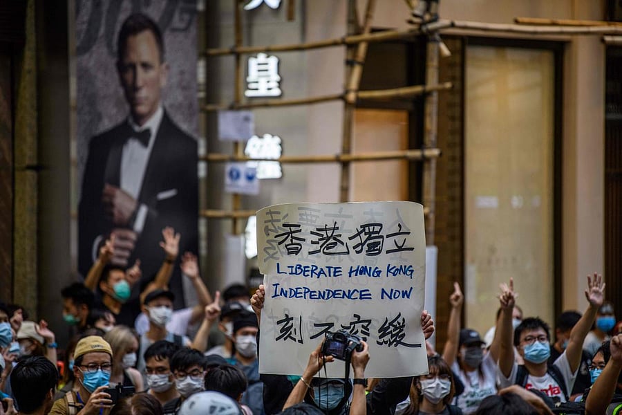 This file photo taken on July 1, 2020 shows protesters chant slogans and hold a placard during a rally against a new national security law in Hong Kong, on the 23rd anniversary of the city's handover from Britain to China. Credit: AFP File Photo