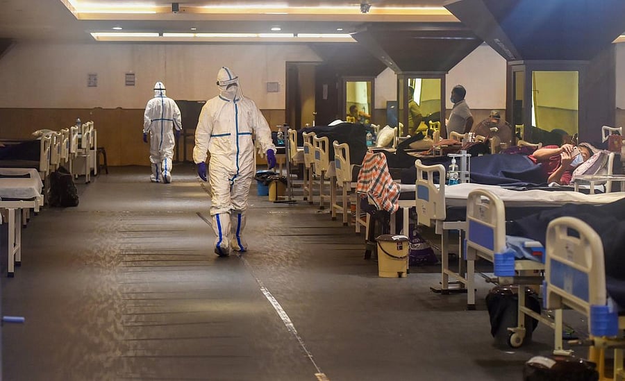 Medics attend to Covid-19 patients inside an isolation ward in Shehnai Banquet Hall near Lok Nayak Jai Prakash (LNJP) Hospital, in New Delhi, Saturday, July 11, 2020. Credit: PTI Photo