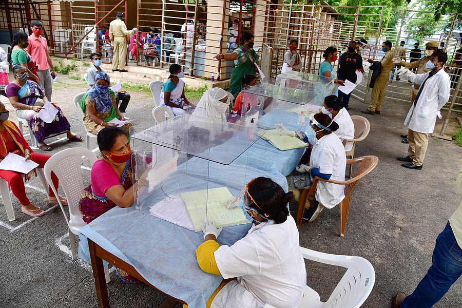 Medics screen people for Covid-19 diagnosis, at a government hospital in Hyderabad, Friday, July 10, 2020. Credit: PTI Photo