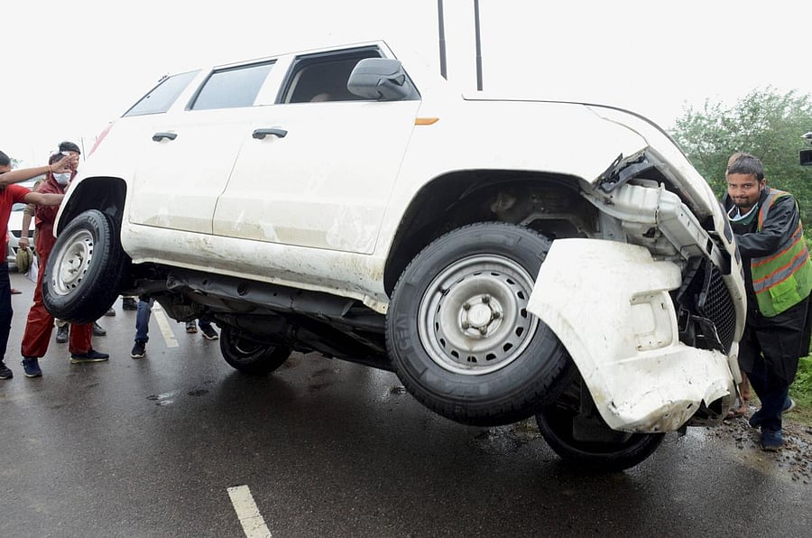 A vehicle being pushed upright near the encounter site where gangster Vikas Dubey (PTI Photo)