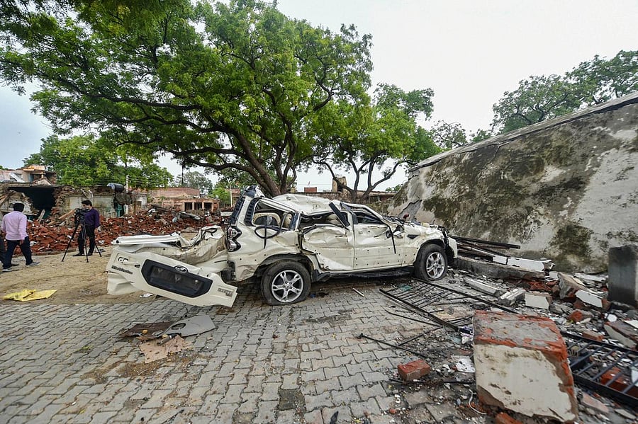 Police at Vikas Dubey's demolished house (PTI Photo)