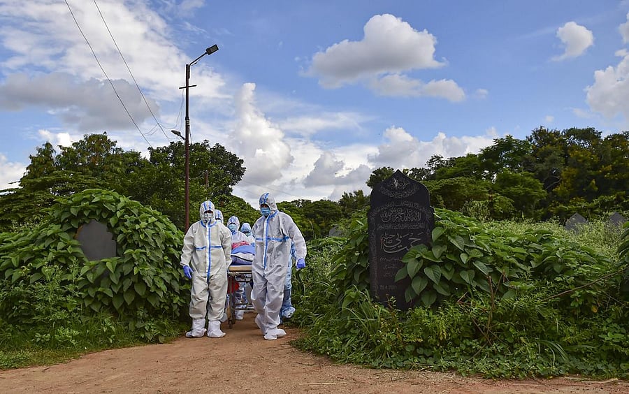 Volunteers from 'Mercy Angel' perform the last rites of a Covid-19 victim, at Khuddus Saab burial ground in Bengaluru, Saturday, July 11, 2020. PTI File Photo