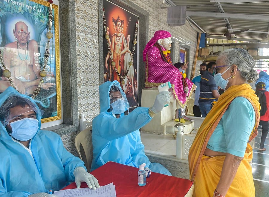 Health workers carry out COVID-19 tests, at Dadar in Mumbai, Saturday, July 18, 2020. (PTI Photo)